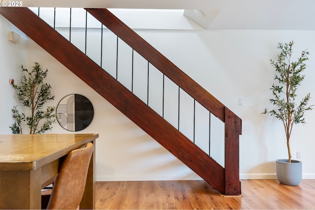 staircase with hardwood / wood-style floors