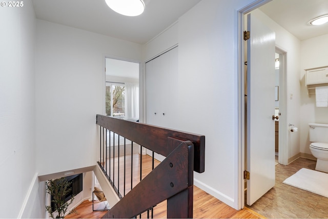 corridor with light hardwood / wood-style flooring