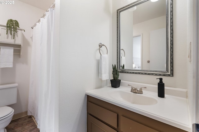 bathroom featuring hardwood / wood-style floors, vanity, and toilet