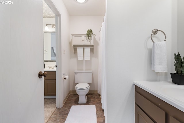 bathroom with toilet and vanity