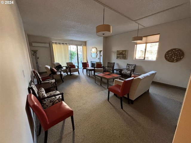 carpeted living room with a wall mounted air conditioner and a textured ceiling