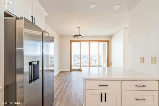 kitchen with pendant lighting, white cabinets, stainless steel refrigerator with ice dispenser, a chandelier, and light hardwood / wood-style floors