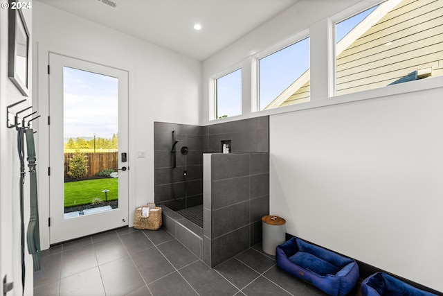 misc room with plenty of natural light and dark tile flooring