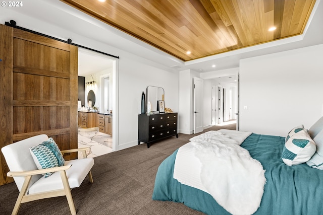 carpeted bedroom featuring a barn door, a tray ceiling, connected bathroom, and wooden ceiling