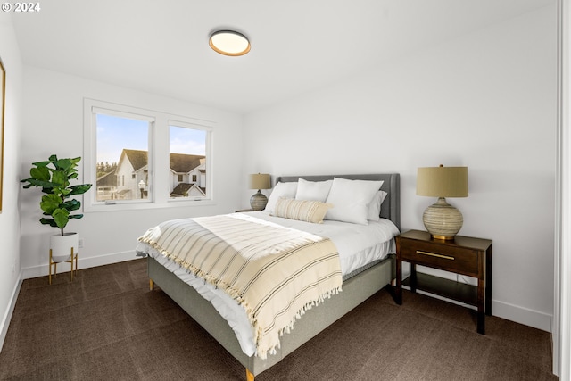 bedroom featuring dark colored carpet