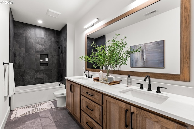 full bathroom featuring tiled shower / bath, double vanity, toilet, and tile floors