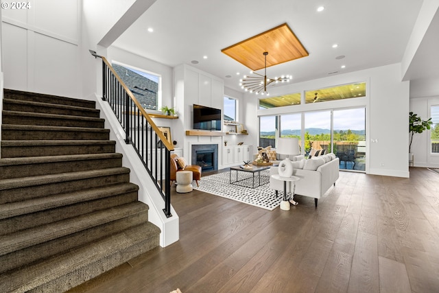 living room with a chandelier and dark wood-type flooring