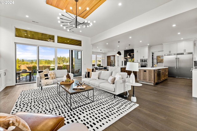 living room featuring dark hardwood / wood-style floors and a notable chandelier