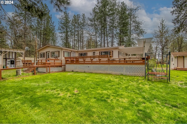 back of property with a deck and a lawn