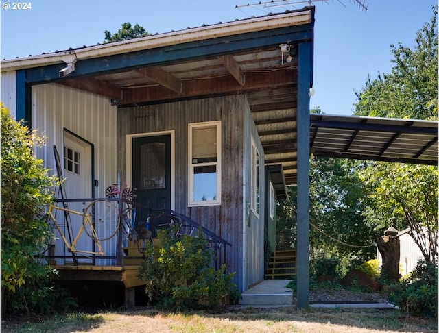 view of exterior entry featuring covered porch