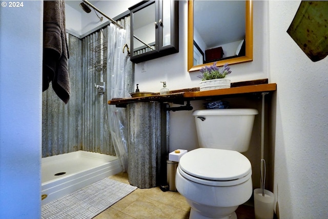 bathroom with tile patterned flooring, curtained shower, and toilet