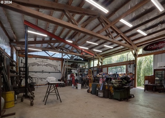 miscellaneous room featuring concrete flooring and lofted ceiling