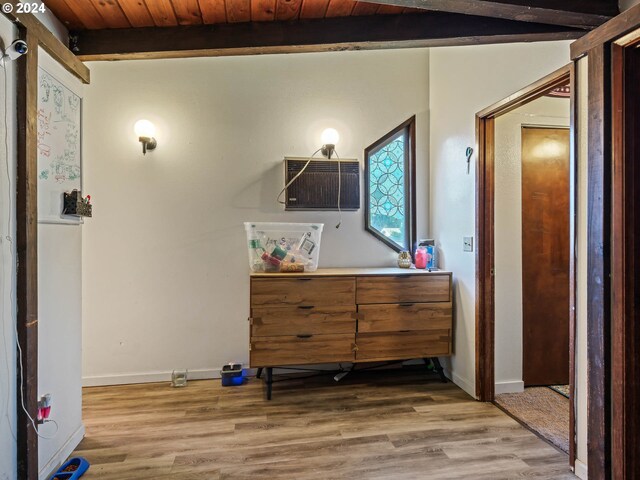 interior space with hardwood / wood-style floors, beamed ceiling, and wooden ceiling