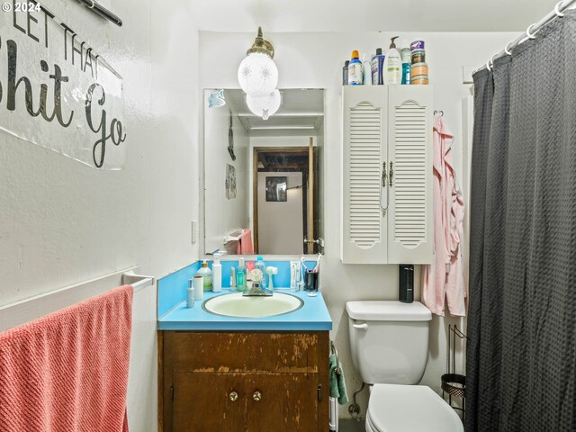 bathroom featuring vanity and toilet