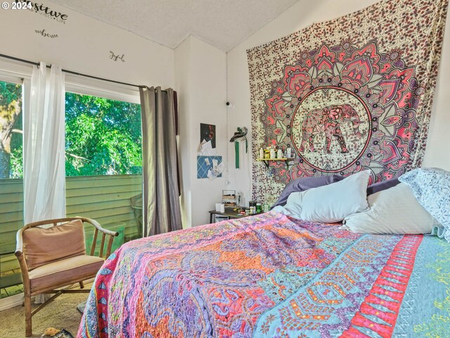 carpeted bedroom featuring lofted ceiling, multiple windows, and a textured ceiling