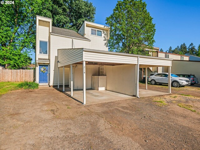 back of property with a carport