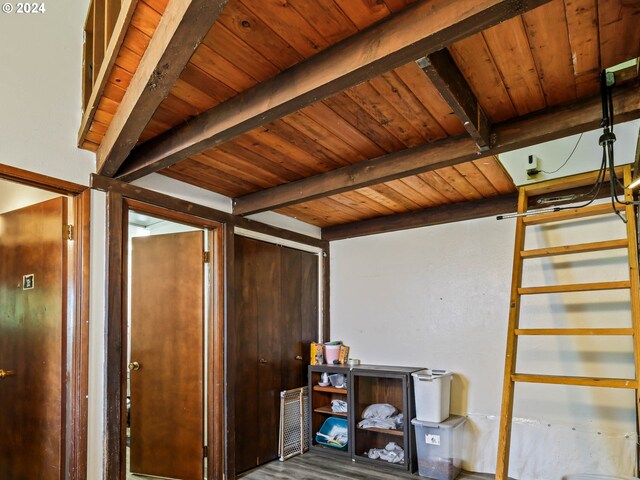 interior space featuring beamed ceiling, wood-type flooring, and wooden ceiling