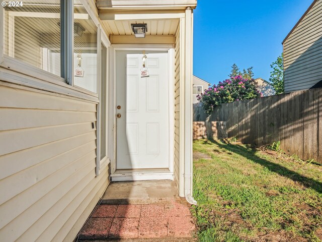 doorway to property with a yard