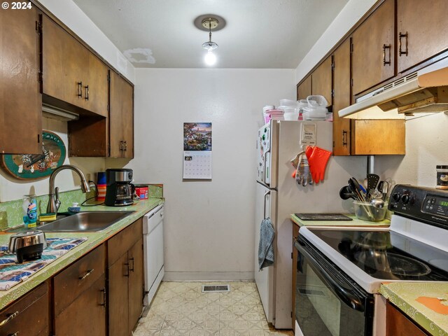 kitchen featuring sink and white appliances