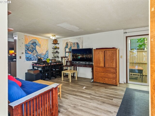 bedroom featuring a textured ceiling and wood-type flooring