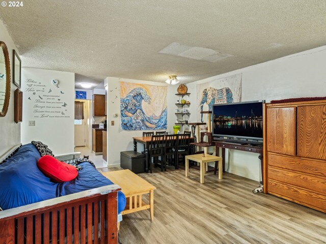 living room featuring hardwood / wood-style floors and a textured ceiling