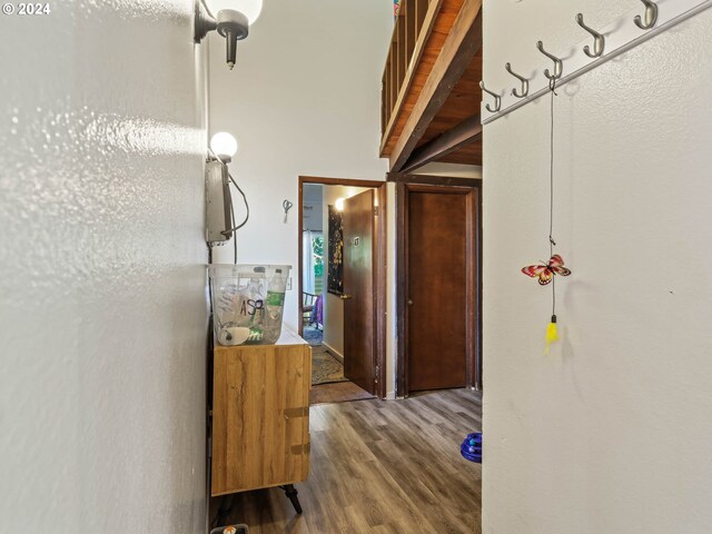 corridor with beam ceiling and wood-type flooring