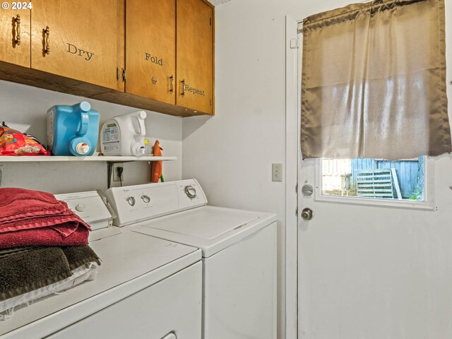 laundry area with independent washer and dryer and cabinets