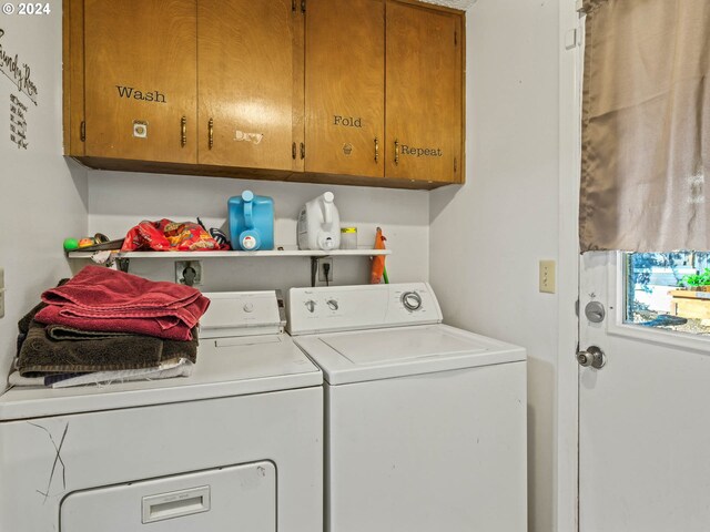 clothes washing area with washer and clothes dryer and cabinets