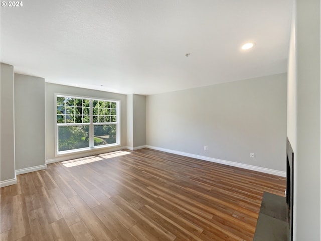 unfurnished living room featuring wood-type flooring