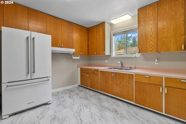 kitchen featuring high end refrigerator and sink