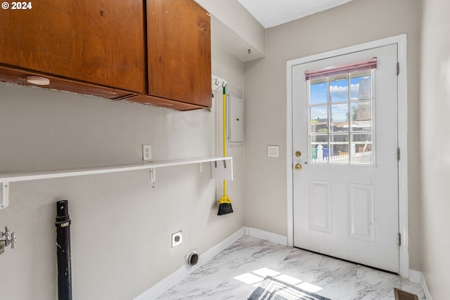 clothes washing area featuring cabinets and electric dryer hookup