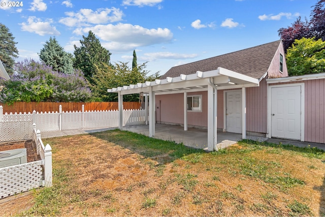 back of property featuring a patio, a yard, and a pergola