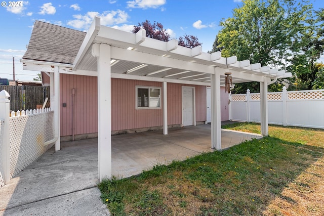 back of property with a carport and a lawn