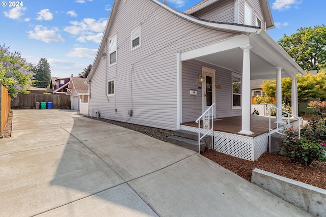 exterior space with a porch and an outdoor structure