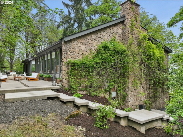 view of side of property featuring a sunroom