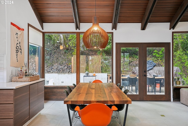 tiled dining space with vaulted ceiling with beams, french doors, and wooden ceiling