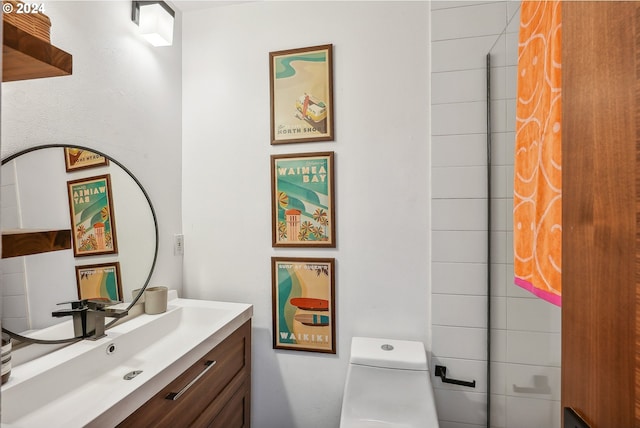 bathroom with toilet and vanity
