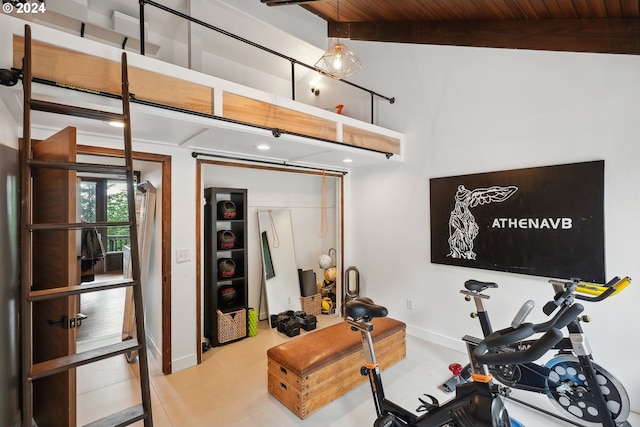 exercise area with tile patterned flooring, wooden ceiling, and vaulted ceiling