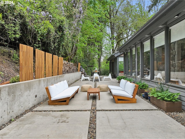 view of patio with an outdoor hangout area and fence