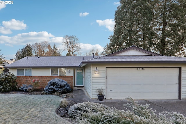 ranch-style house featuring a garage and a front lawn