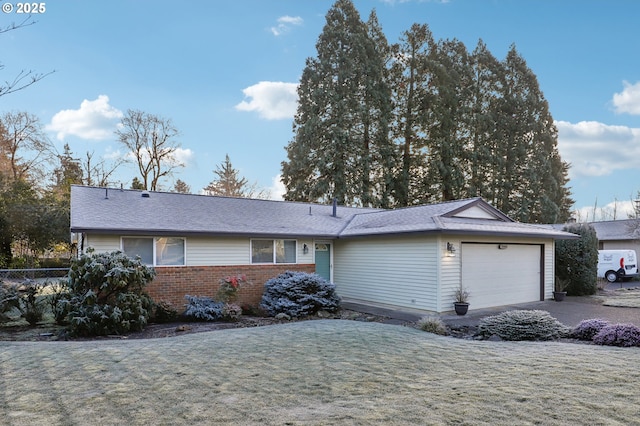 single story home featuring a garage and a front yard