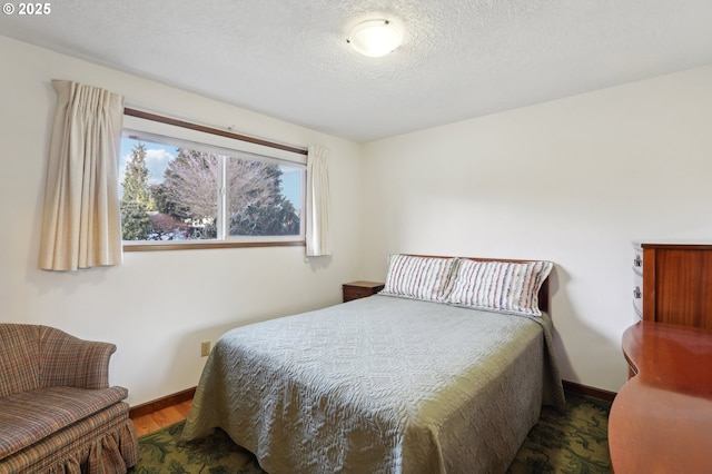 bedroom featuring dark hardwood / wood-style floors and a textured ceiling