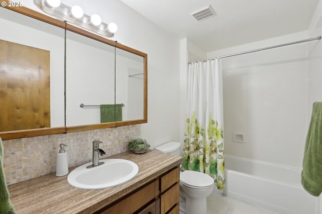 full bathroom featuring toilet, vanity, shower / bath combination with curtain, tile patterned flooring, and decorative backsplash