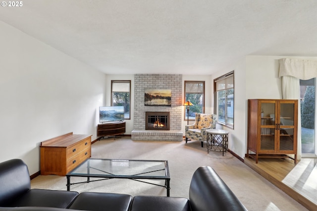 living room featuring a brick fireplace and light colored carpet