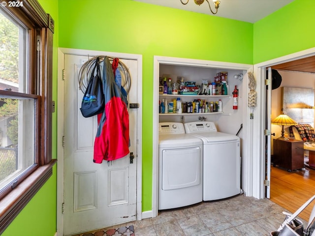 laundry area featuring washer and dryer and light hardwood / wood-style floors