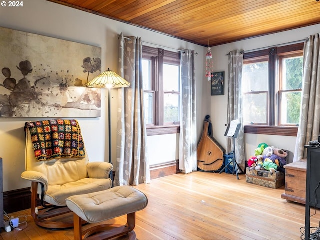 living area with wooden ceiling, a wealth of natural light, and wood-type flooring