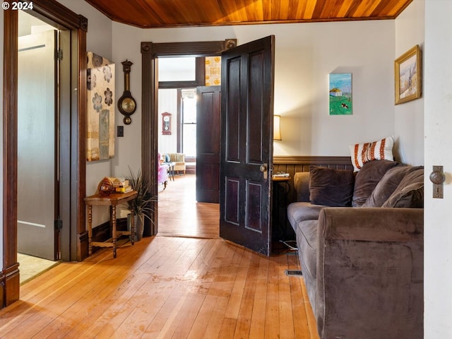 1006 Pine St NE, Silverton, OR 97381 - living area with light wood-style floors, wooden ceiling, and wainscoting