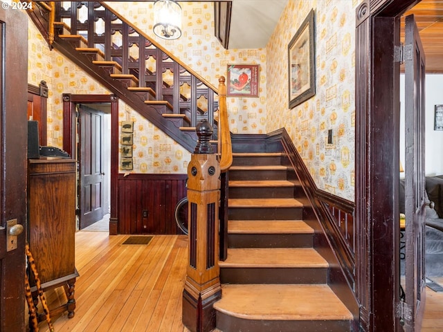 staircase with hardwood / wood-style floors