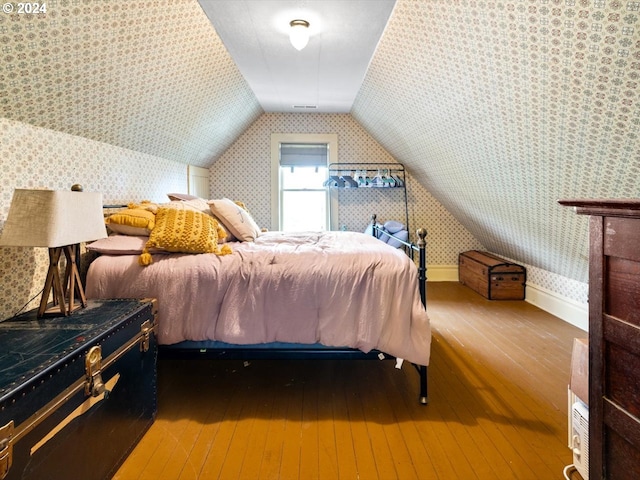 bedroom featuring vaulted ceiling and hardwood / wood-style flooring