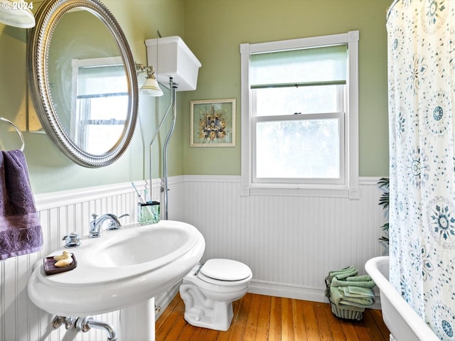 bathroom featuring hardwood / wood-style flooring and toilet